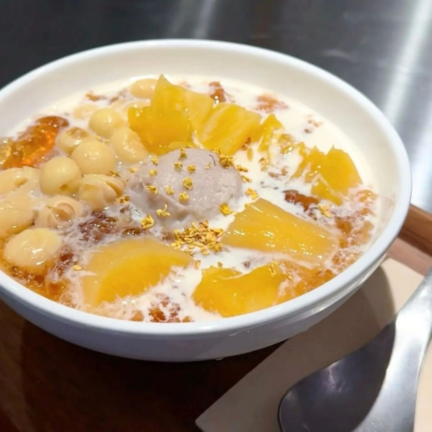 Bowl with mango, lotus seeds, taro ball and osmanthus milk at K House, a Chinese Restaurant in Columbus